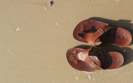 leather sandals on a beach