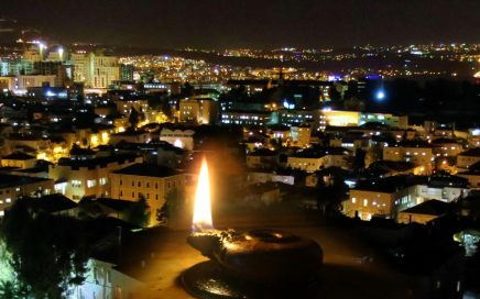 Jerusalem at night with an ancient lit lamp superimposed on the picture